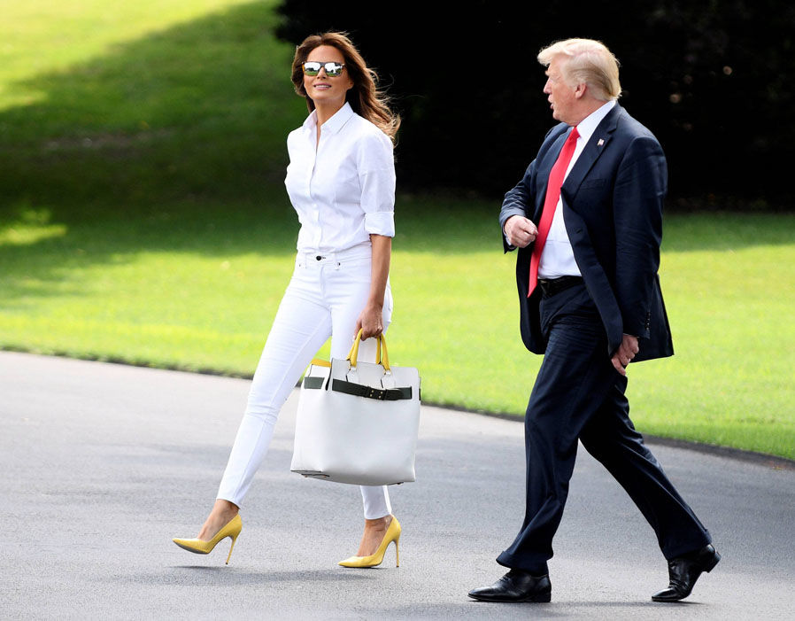 US President Donald Trump and First Lady Melania Trump walk to Marine One from the White House