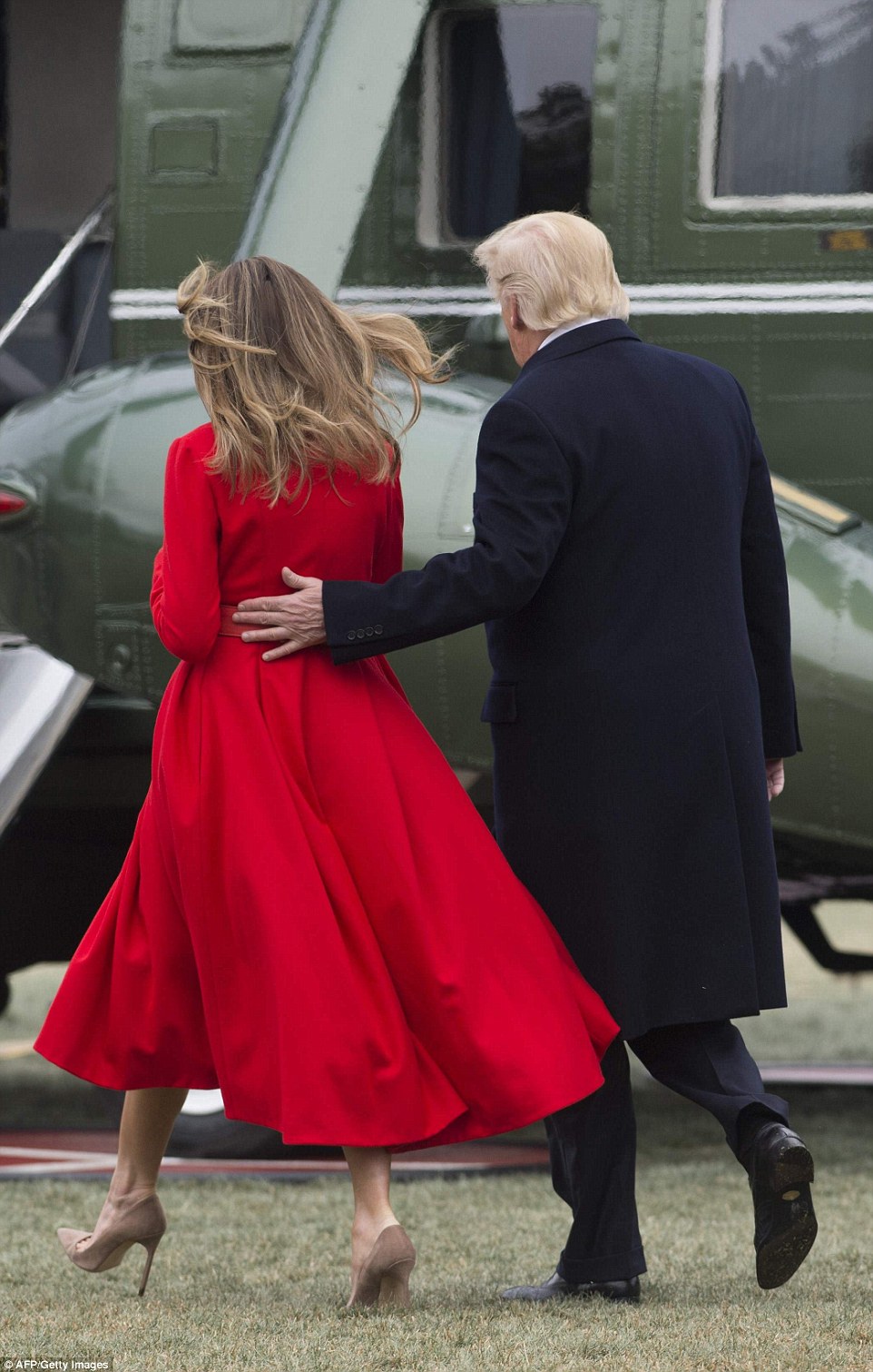 She paired the coat with a towering pair of nude suede heels